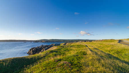 Road to Cape Bona Vista lighthouse station, Newfoundland,  Panoramic vista, bright blue late summer morning over Atlantic Canada.の写真素材