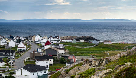 Bonavista, Newfoundland, Canada, on mid summer overcast day.   Village community alongside the sea.  People staying inside on blustery day.の写真素材