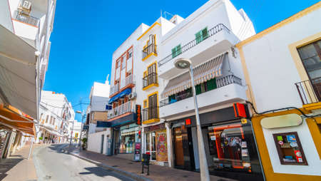 Postcards from Ibiza.  Shops, parlors, cafes and convenience stores line bright sunny streets of Ibiza's largest town, take a seat and relax in St Antoni de Portmany Balearic Islands, Spain.のeditorial素材