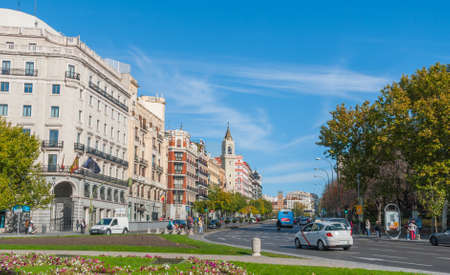 Postcards from Spain.  Tourists and citizens alike in the City of Madrid, Spain.  People wait cross the Street, Calle de Alcia.  Pedestrian crossing street scene.  Urban life with street traffic.のeditorial素材