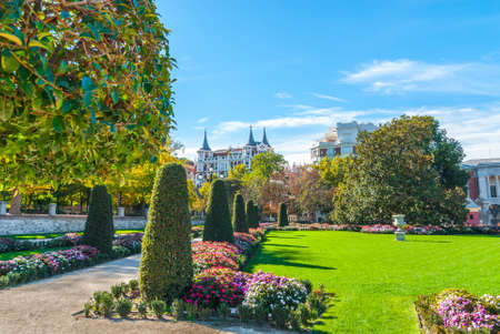 Warm Autumn day in the beautiful gardens of flowers, shrubs, trees and green space in Retiro Park of Madrid, Spain.  Bright sunshine on unusually warm November day.の写真素材