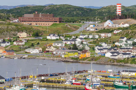 Small village community, Twillingate, Newfoundland.  Fishing boats docked along the shoreline in this coastal town, local roads connect the community along the Island's edges.のeditorial素材