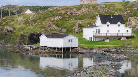 Small village, shacks on stilts over the water  in Twillingate, Newfoundland.  Homes along shoreline in this coastal village,の写真素材