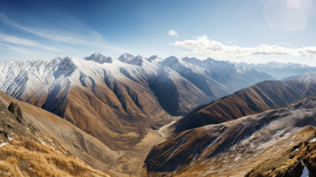 Mountain landscape panorama with snow-capped peaks and blue skyの素材