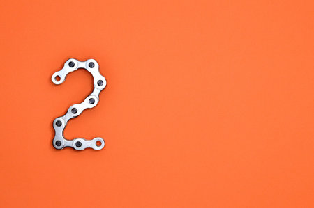 Alphabet made of bicycle spanners on orange background with copy space