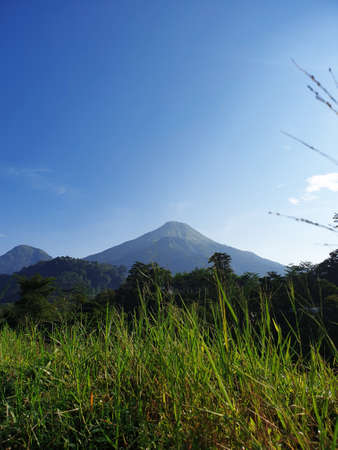 Mount Penanggungan with blue skyの写真素材