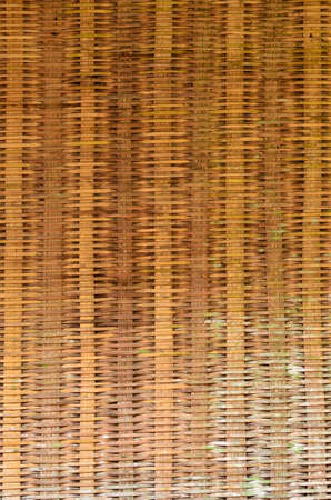 yellow-brown wicker bamboo texture backgroundの写真素材