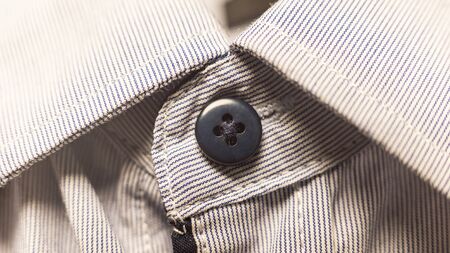 dark button down collar light shirt. background of white shirt with stripes.の写真素材
