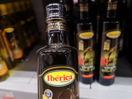 Glass bottle of natural olive oil Iberica Extra Virgin near a grocery shelf in a retail store May 5, 2020 in Russia, Tatarstan, Kazan, Richard Zorge Street 11bのeditorial素材