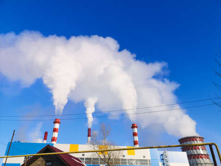 harmful to health smoke from industrial pipes from a thermal power plant in the cityの写真素材