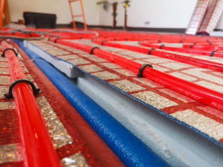 Cross-linked polyethylene heating pipes for underfloor heating on a heat-insulating material and polystyrene foam insulation on a concrete floor.の写真素材
