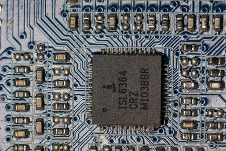 microcircuits and a square motherboard on a motherboard inside a personal computer.