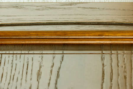 vintage top edge of a classic lacquered kitchen facade texture closeup. background for website template of solid wood textured decorative itemの写真素材