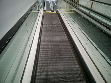 escalator stairs in a shopping center on the rise to the topの写真素材