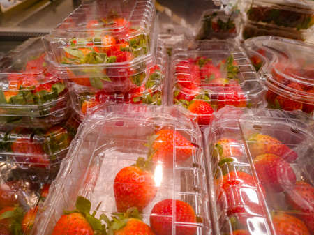 selling strawberries in containers at a small grocery supermarket.の写真素材