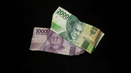Indonesian rupiah banknotes. Indonesian rupiah currency type on black background.の写真素材
