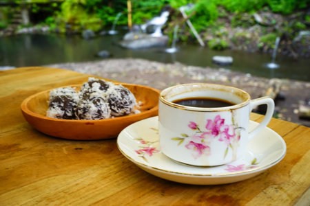 Coffee and cookies on the wooden table with nature background.の写真素材