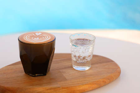coffee ice coffee with cookies latte cappuccino beans heart girl with sweets Dubai UAE Arab coffee water pool sea view pool view with cafeの写真素材