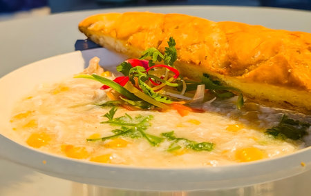 Savory dish featuring a crisp, golden-brown folded crepe lavishly garnished with edible flowers and fresh herbs.の写真素材