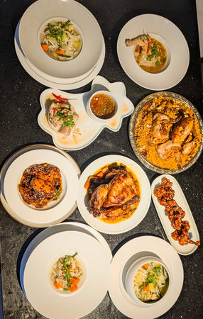 A top-down view showcases a diverse and professionally styled spread of chicken dishes, including...
