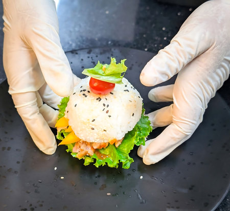 Rice burger featuring compacted sesame rice buns, grilled meat, crisp lettuce, pickled radish and...