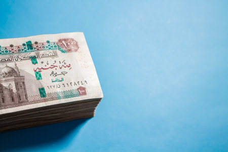 Egyptian money bundles of currency 100 pound on ocean blue Backgroundの写真素材