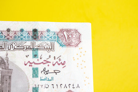 Egyptian money paper of currency 100 pound on yellow Background