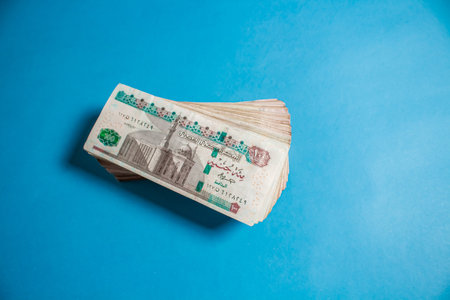 Egyptian money bundles of currency 100 pound on ocean blue Background