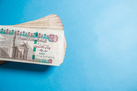 Egyptian money bundles of currency 100 pound on ocean blue Backgroundの写真素材