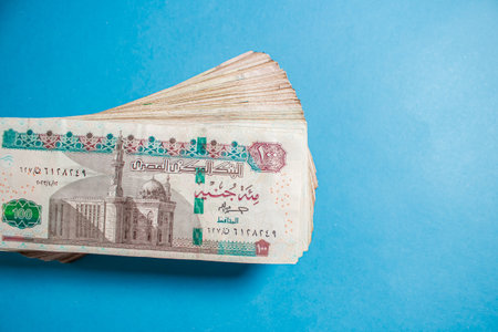 Egyptian money bundles of currency 100 pound on ocean blue Backgroundの写真素材