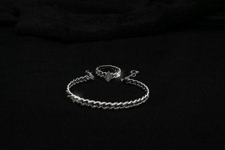 A stunning set featuring a bracelet paired with a matching ring. Both pieces exhibit a delicate and sophisticated design, perfect for adding a touch of luxury to any outfit. Ideal for evening wear, weddings, or special occasions.の写真素材