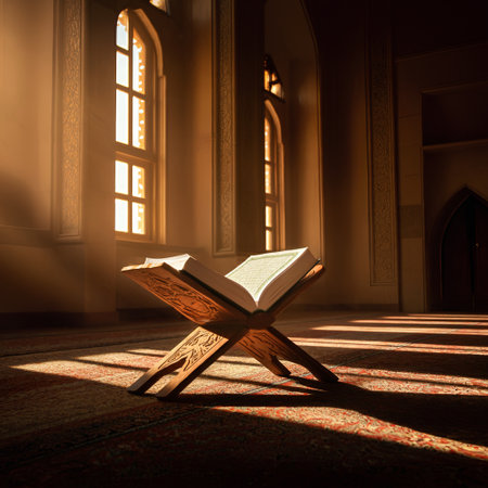 The holy Quran is open on a wooden rehal inside a peaceful mosque with beautiful sunbeams streaming through the windows and illuminating the sacred book and carpetの素材