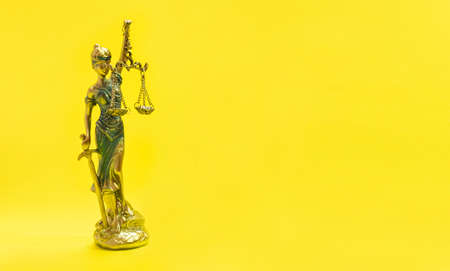 Statue of Justice - lady justice, law minimalist concept on yellow background.の写真素材