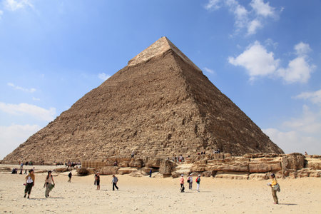 A pyramid in the Giza district of Cairo. Tourists located in front of the pyramid. Pyramids are on the Unesco world heritage list. Cairo, Egypt.のeditorial素材