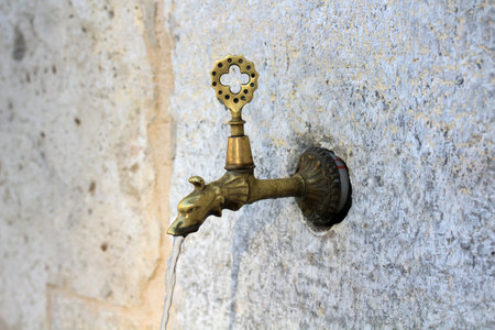 Animal-shaped spout of a historical fountain in Konya Sahibata district. An example from Turkish metal art.の写真素材