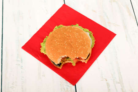 Homemade hamburger with fresh vegetables on wooden table, top viewの写真素材