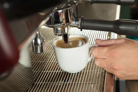 Close-up of espresso pouring from coffee machineの写真素材