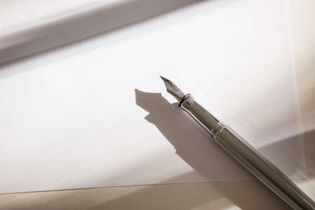 High Angle View Of  Fountain Pen On Blank Paperの写真素材