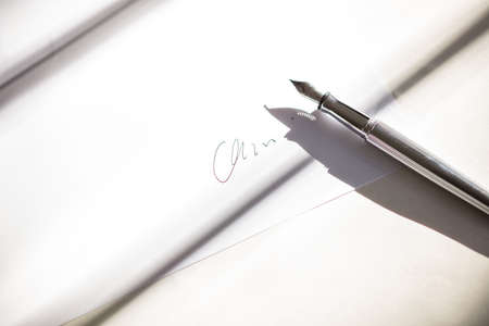 High Angle View Of Fountain Pen With text  On Paperの写真素材
