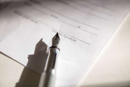 Close-up of Contract form with open fountain penの写真素材