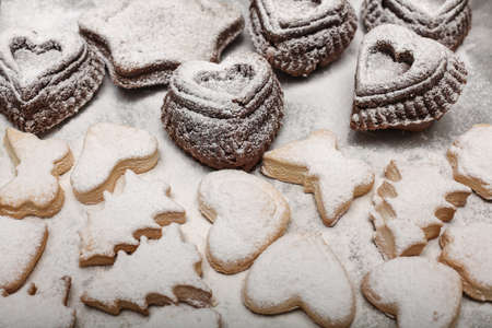 Close up view of freshly baked new year cookies on snowy background