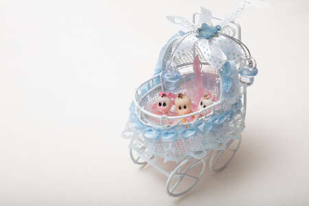 High angle view of Baby dolls in toy baby stroller on white background with copy space, high quality...