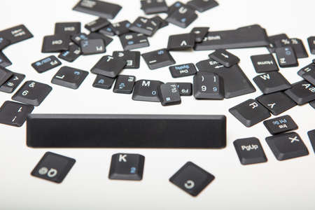 Composed of loose key covers from a computer with the empty space key in a close up low angle conceptual viewの写真素材