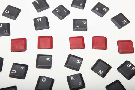 Overhead view of a composed  alphanumeric computer keyboard with five blank red keys on silver gradient to white with copy space aboveの写真素材