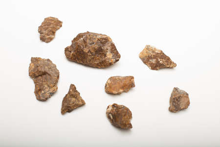 Different sizes of flintstones on a white backgroundの写真素材