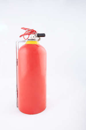 Side view of a portable red fire extinguisher on a white surface with copy space, High resolution pictureの写真素材