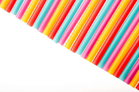 Top view of drinking straw colorful plastic tubes over white as abstract background with copy spaceの写真素材
