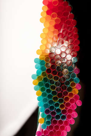 Top view of drinking straws on black and white background with copy spaceの写真素材
