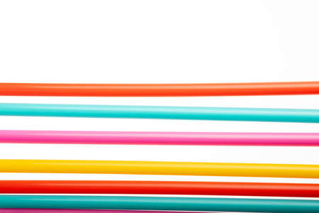 Drinking straw colorful plastic tubes over white as abstract background with copy spaceの写真素材