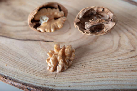 Walnuts on a wooden plate . shallow depth of field